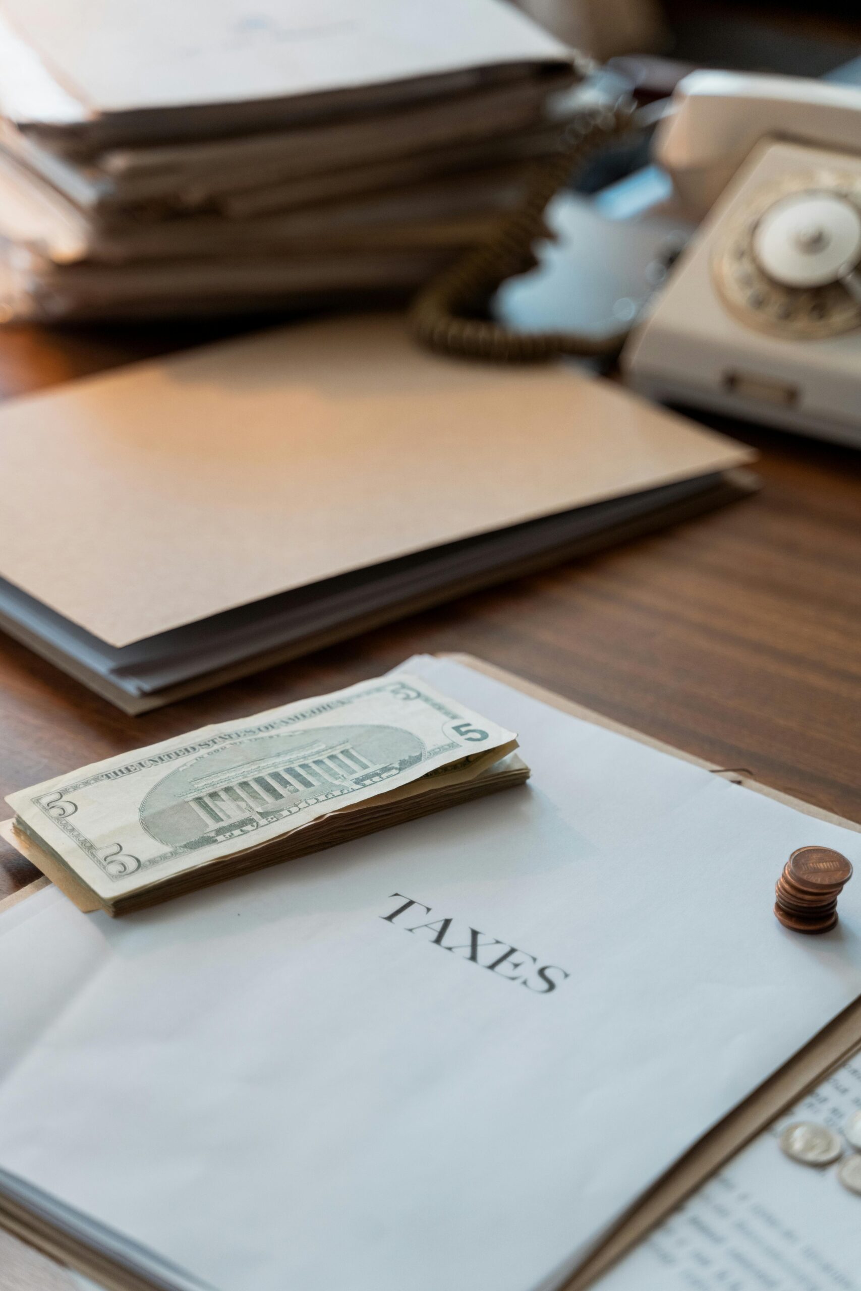 Retro-themed desk with tax papers and money, showcasing vintage office aesthetics.